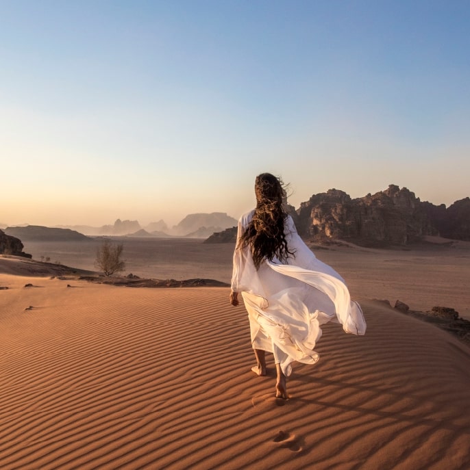 Woman walking through the desert in Jordan